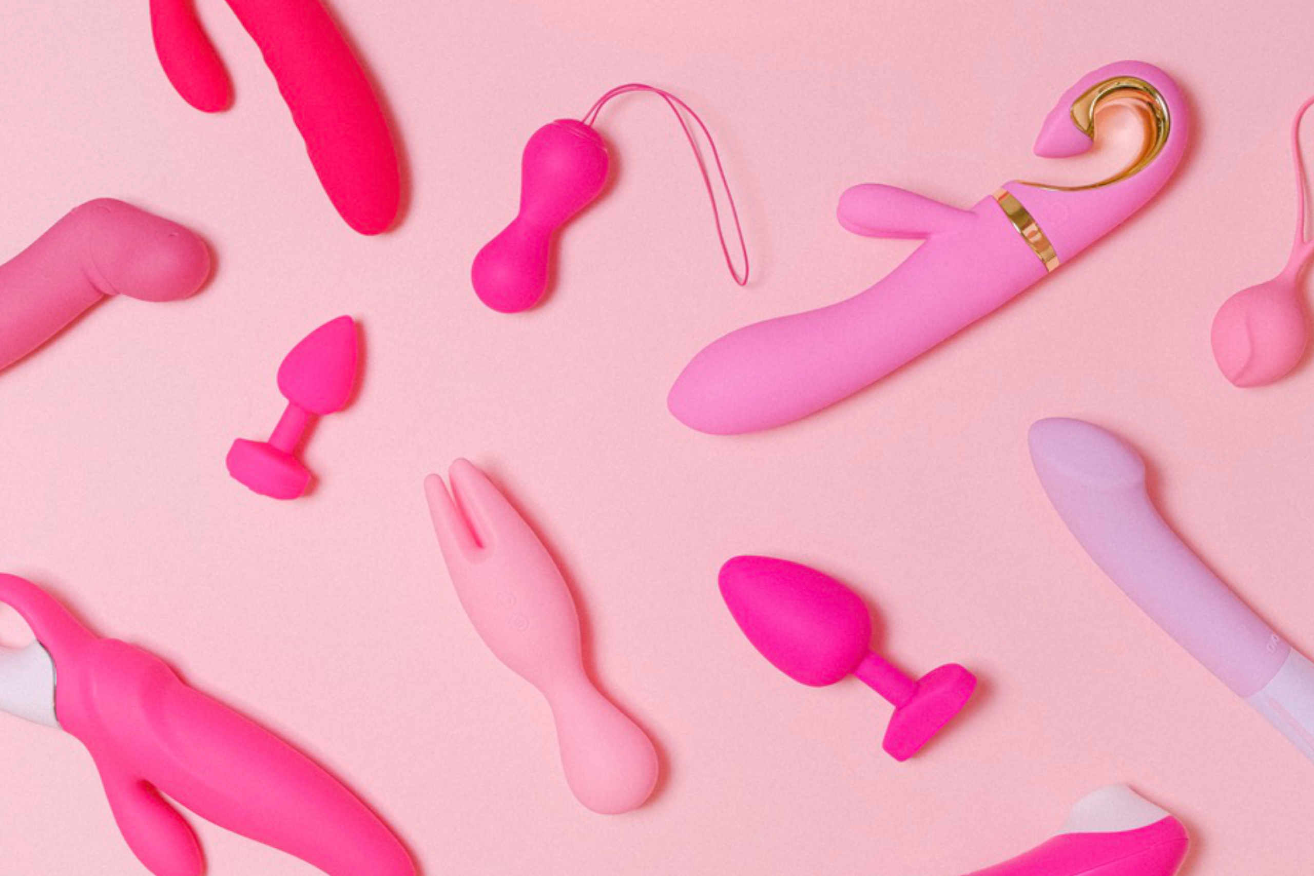 Variados tipos de brinquedos sexuais femininos em diferentes tonalidades de rosa.